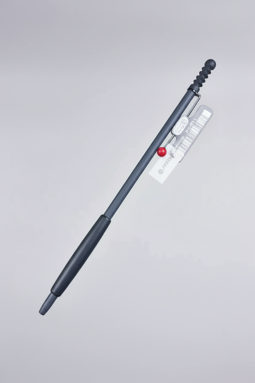 A dark gray tactical pen with a textured grip, a small red accent bead, and a clear plastic clip containing white tabs, shown on a light gray gradient background.